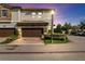 Beautiful exterior elevation showcasing a two-story townhome with a brick driveway and manicured landscaping at 8541 Spyglass Ln, Davenport, FL 33896