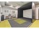 Modern golf simulator room with seating, equipment, and lighting for immersive training and fun at 8541 Spyglass Ln, Davenport, FL 33896