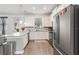 Open-concept kitchen with white cabinets, stainless steel appliances, and an island overlooking the backyard at 8541 Spyglass Ln, Davenport, FL 33896