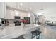 Bright kitchen features white cabinets, stainless steel appliances, and a large center island with seating at 8541 Spyglass Ln, Davenport, FL 33896