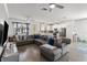 Open-concept living room flowing into a modern kitchen, featuring hardwood floors and contemporary decor at 8541 Spyglass Ln, Davenport, FL 33896