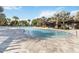 Inviting community pool area with palm trees, fountains, and ample seating at 8541 Spyglass Ln, Davenport, FL 33896