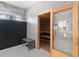 Relaxing sauna room with wooden benches, glass door, and a tiled wall, providing a tranquil spa experience at 8541 Spyglass Ln, Davenport, FL 33896
