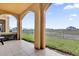 Balcony with arched supports overlooking a grassy field at 2774 Bella Vista Dr, Davenport, FL 33897