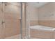 Bathroom features a separate glass shower and soaking tub combo surrounded by ceramic tile at 2774 Bella Vista Dr, Davenport, FL 33897