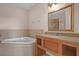 Bright bathroom featuring a soaking tub and vanity with a granite countertop at 2774 Bella Vista Dr, Davenport, FL 33897