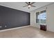 Empty bedroom with dark accent wall, ceiling fan, window and tile flooring at 2774 Bella Vista Dr, Davenport, FL 33897