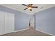 Neutral bedroom showing fan, closet, and access to another room at 2774 Bella Vista Dr, Davenport, FL 33897