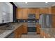 Kitchen featuring stainless steel appliances, granite counters and dark gray walls at 2774 Bella Vista Dr, Davenport, FL 33897