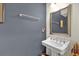 This powder room features a pedestal sink, framed mirror, and a soothing neutral color palette at 2774 Bella Vista Dr, Davenport, FL 33897