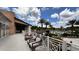 Balcony view showcasing outdoor seating areas, swimming pool, and lush landscaping under a sunny sky at 1515 Carey Palm Cir, Kissimmee, FL 34747