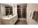 Modern bathroom with double sinks, a spacious glass-enclosed shower, and a separate linen closet at 1515 Carey Palm Cir, Kissimmee, FL 34747