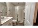 Well-lit bathroom features a glass shower, vanity, and decorative accents at 1515 Carey Palm Cir, Kissimmee, FL 34747