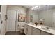 Bright bathroom features double vanity, neutral paint, and decorative floral art at 1515 Carey Palm Cir, Kissimmee, FL 34747
