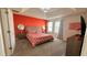 Cozy bedroom with a tray ceiling, a patterned bedspread, and matching bedside lamps at 1515 Carey Palm Cir, Kissimmee, FL 34747