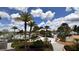 Beautifully landscaped community pool area with palm trees, walkways, and ample seating at 1515 Carey Palm Cir, Kissimmee, FL 34747