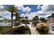 Scenic view of the community pool and lush landscaping with tall palm trees and plenty of seating at 1515 Carey Palm Cir, Kissimmee, FL 34747