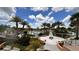 Landscaped view of the community pool featuring lush greenery, palm trees, and various seating arrangements at 1515 Carey Palm Cir, Kissimmee, FL 34747