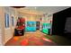 Well-lit game room featuring classic arcade claw machines and vibrant decor, perfect for leisure and entertainment at 1515 Carey Palm Cir, Kissimmee, FL 34747