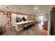 Bright, open kitchen with white cabinetry, a large island, stainless steel appliances and pendant lighting at 1515 Carey Palm Cir, Kissimmee, FL 34747