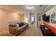 Comfortable living room featuring a cozy couch, TV, and view into the bedroom at 1515 Carey Palm Cir, Kissimmee, FL 34747