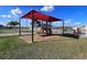 Modern playground with a red shade structure and slides at 340 Elderberry Ct, Kissimmee, FL 34759