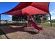 Community playground with shaded play structure and slide at 340 Elderberry Ct, Kissimmee, FL 34759