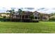 Large backyard with a screened enclosure and lush lawn at 9210 Southern Breeze Dr, Orlando, FL 32836