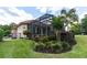 Landscaped backyard with screened patio and lush greenery at 9210 Southern Breeze Dr, Orlando, FL 32836