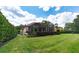 Landscaped backyard with a screened-in patio at 9210 Southern Breeze Dr, Orlando, FL 32836