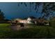 Night view of backyard, patio furniture and home at 9210 Southern Breeze Dr, Orlando, FL 32836