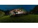 Screened patio with string lights and beautiful landscaping at night at 9210 Southern Breeze Dr, Orlando, FL 32836