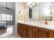 Double vanity bathroom with wood cabinets and updated fixtures at 9210 Southern Breeze Dr, Orlando, FL 32836