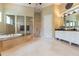 Primary bathroom with soaking tub, walk-in shower, and double vanity at 9210 Southern Breeze Dr, Orlando, FL 32836