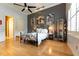 Elegant bedroom with iron bed frame and hardwood floors at 9210 Southern Breeze Dr, Orlando, FL 32836