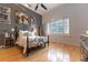 Serene bedroom featuring a metal bed frame and grey accent wall at 9210 Southern Breeze Dr, Orlando, FL 32836