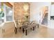 Elegant dining room with glass table, bench seating, and chandelier at 9210 Southern Breeze Dr, Orlando, FL 32836