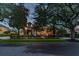 Night view of house exterior with lights and landscaping at 9210 Southern Breeze Dr, Orlando, FL 32836