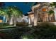 Night view of house exterior with lights and landscaping at 9210 Southern Breeze Dr, Orlando, FL 32836
