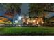 Two-story house exterior at night with landscaping and lighting at 9210 Southern Breeze Dr, Orlando, FL 32836