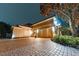 Elegant home with brick driveway and landscaping at night at 9210 Southern Breeze Dr, Orlando, FL 32836