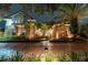 Two-story house with lights illuminating the exterior at night at 9210 Southern Breeze Dr, Orlando, FL 32836