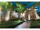Elegant two-story home with landscaped yard and walkway, nighttime view at 9210 Southern Breeze Dr, Orlando, FL 32836