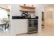 Coffee bar with wine cooler, espresso machine and built-in shelving at 9210 Southern Breeze Dr, Orlando, FL 32836