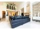 High ceiling living room with a fireplace and black leather sectional at 9210 Southern Breeze Dr, Orlando, FL 32836