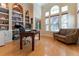 Home office with built-in shelving, large desk, and hardwood floors at 9210 Southern Breeze Dr, Orlando, FL 32836