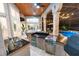 Outdoor kitchen with stainless steel appliances and granite countertops, adjacent to a pool at 9210 Southern Breeze Dr, Orlando, FL 32836