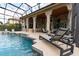 Luxury pool with lounge chairs and an outdoor kitchen at 9210 Southern Breeze Dr, Orlando, FL 32836