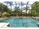 Relaxing screened pool with a view of lush landscaping at 9210 Southern Breeze Dr, Orlando, FL 32836