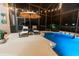 Poolside lounge chairs near a screened-in pool at night at 9210 Southern Breeze Dr, Orlando, FL 32836